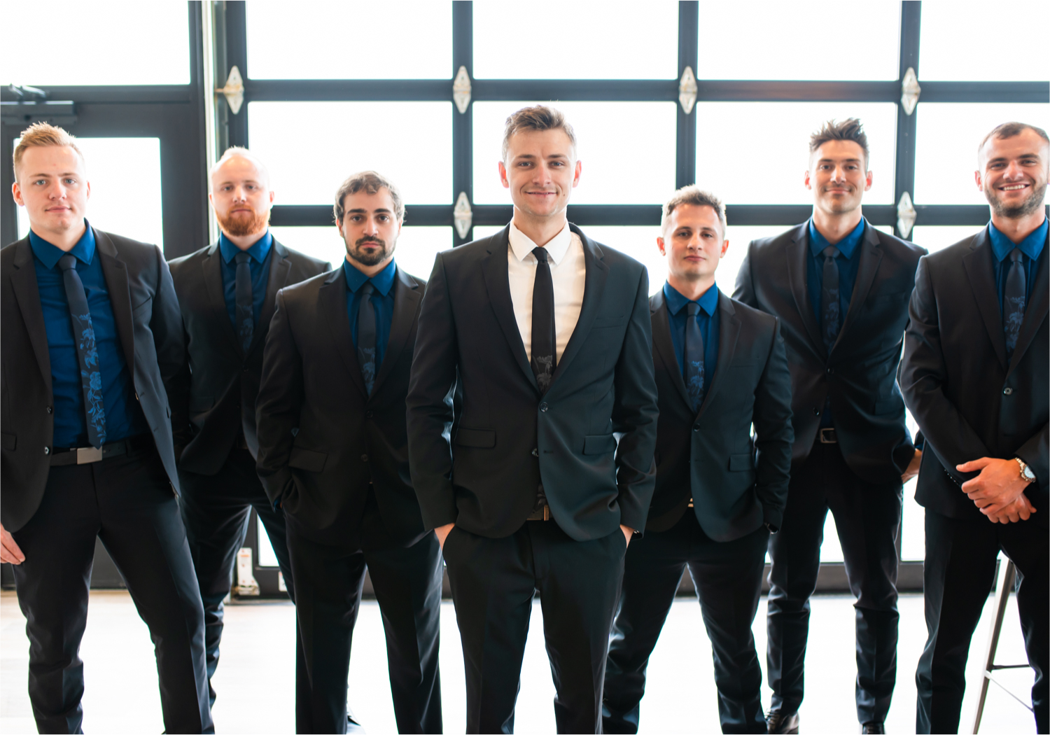 Romantic and Rustic Wedding at The Mill in Windsor | Britni Girard Photography | Colorado based wedding photography and videography team | Groomsmen in bar at The Windsor Mill | Royal Blue and White Wedding | Groomsmen attire from Express