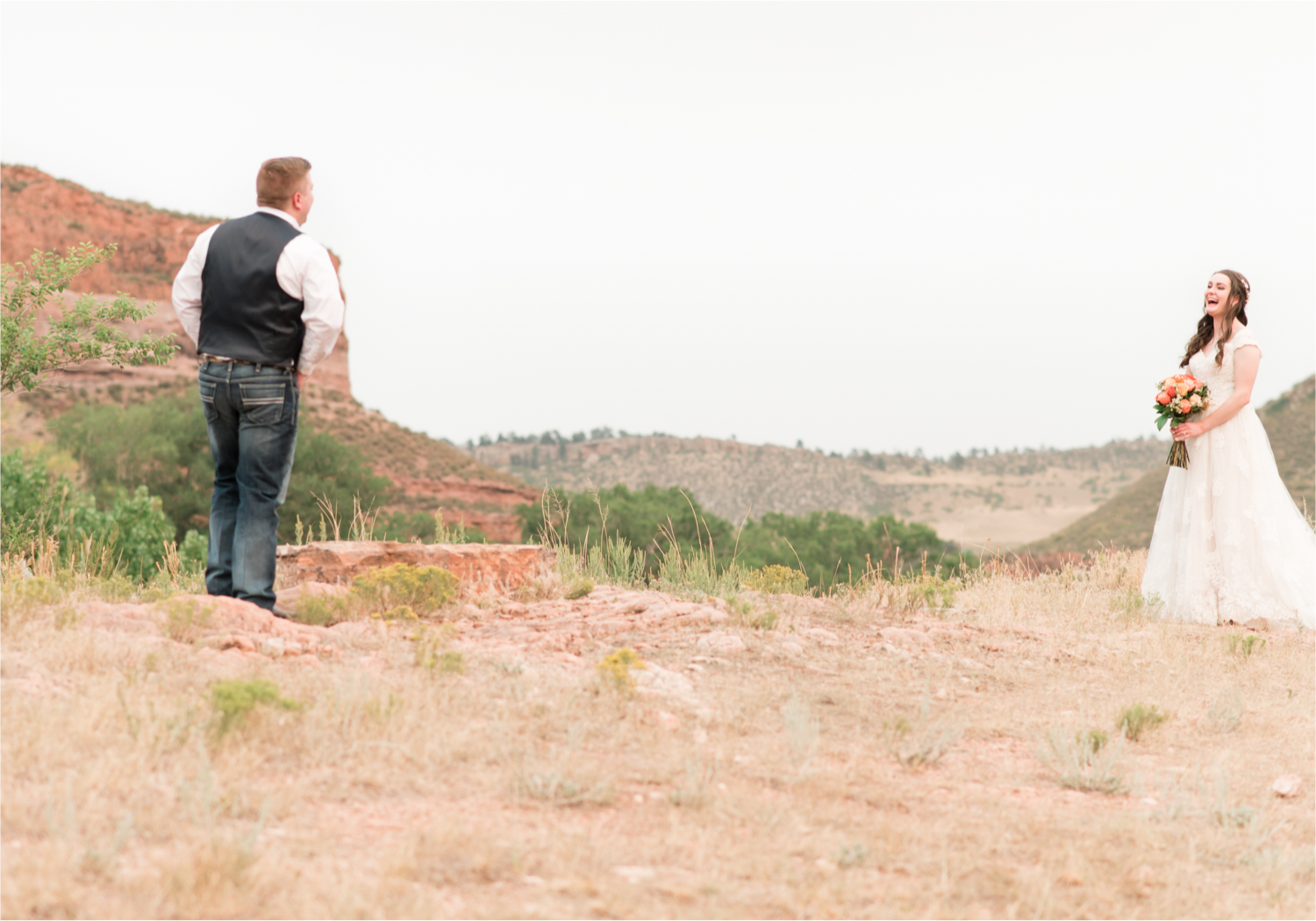 Summer Ellis Ranch Wedding in Loveland Colorado | Britni Girard Photography | Wedding Photo and Video Team | Dark Blue and Orange Bridal Bouquet | First Look on top of colorado mountain | Red Rocks