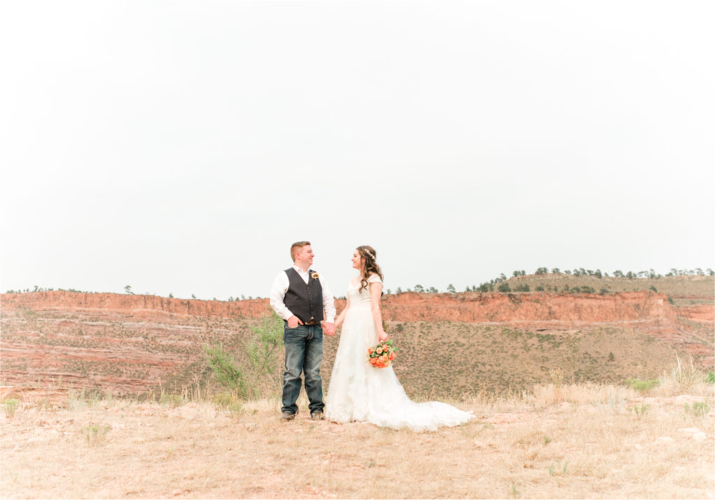 Summer Ellis Ranch Wedding in Loveland Colorado | Britni Girard Photography | Wedding Photo and Video Team | First look on top of Colorado red rock mountains