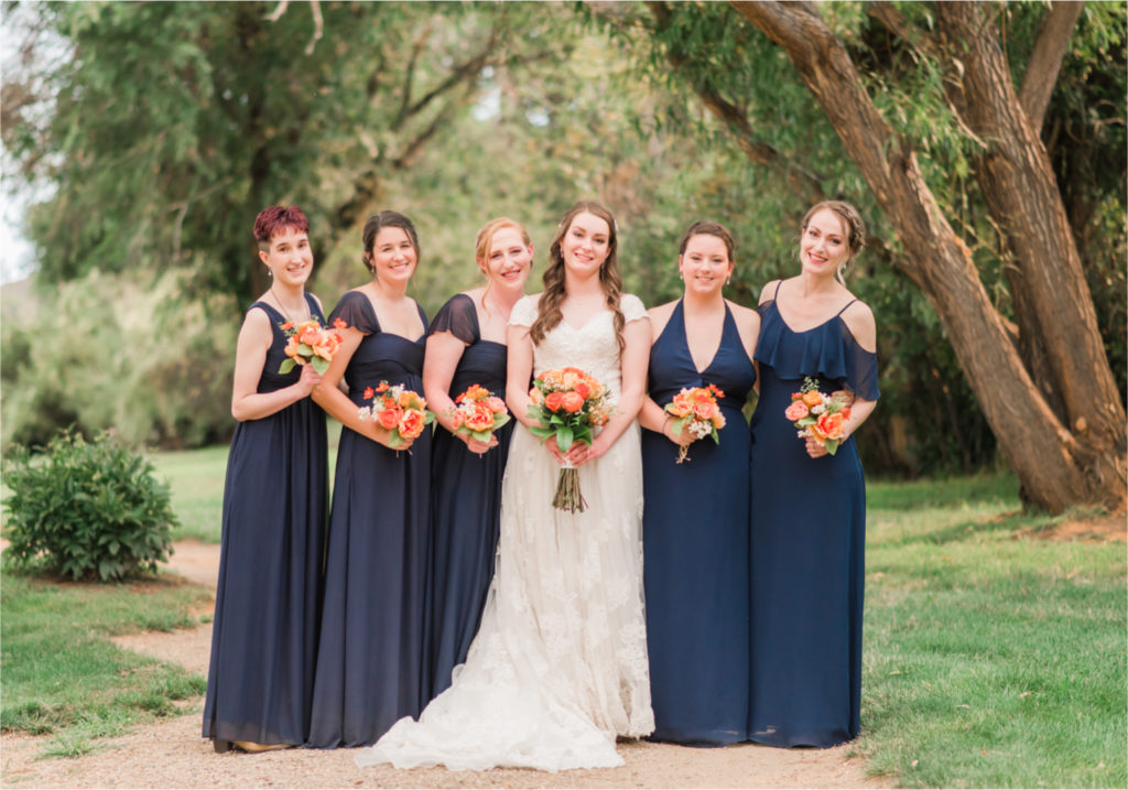 Summer Ellis Ranch Wedding in Loveland Colorado | Britni Girard Photography | Wedding Photo and Video Team | Dark Blue and Orange Bridesmaids