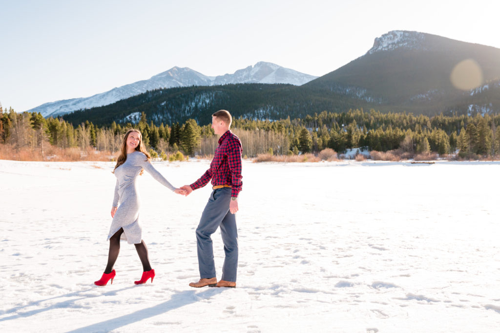 Red Heels on frozen lake for engagement session | Britni Girard Photography - Colorado Wedding Photographer and Video Team | Winter engagement in estes park at Rocky Mountain National Park