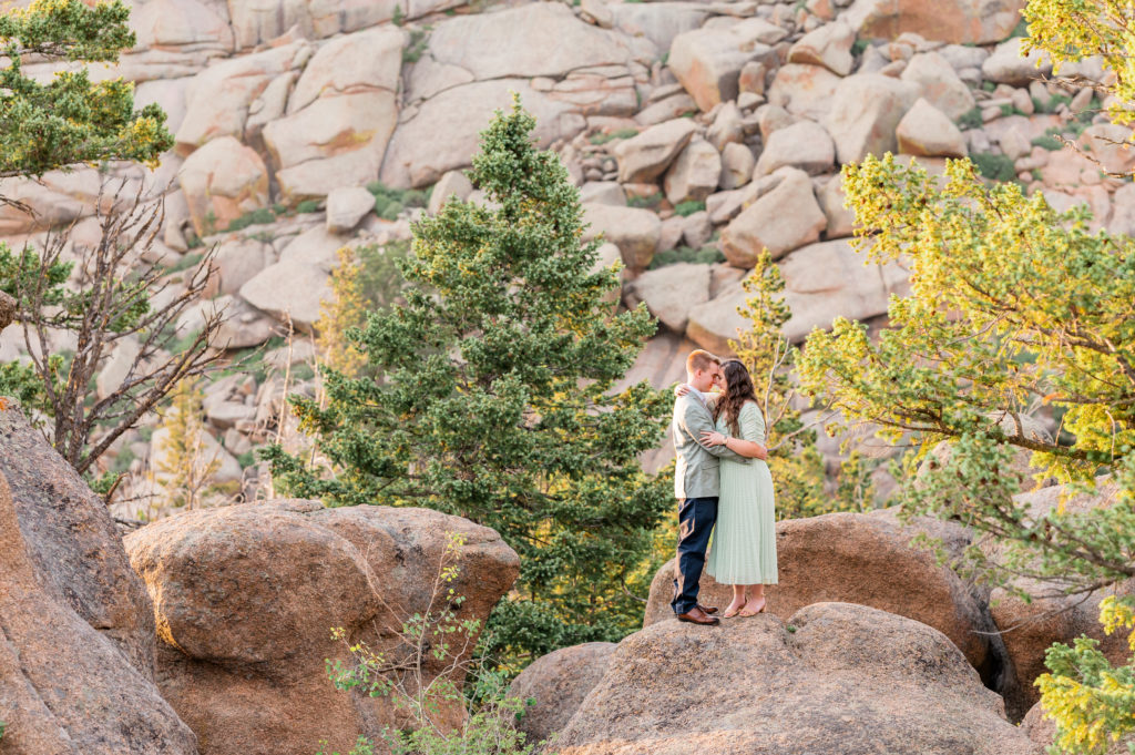 Sage Dress and Suit for Wyoming Engagement session on Rocks | Britni Girard Photography - Colorado Wedding Photography and Video Team | Couple dressed up on mountains for engagement portraits