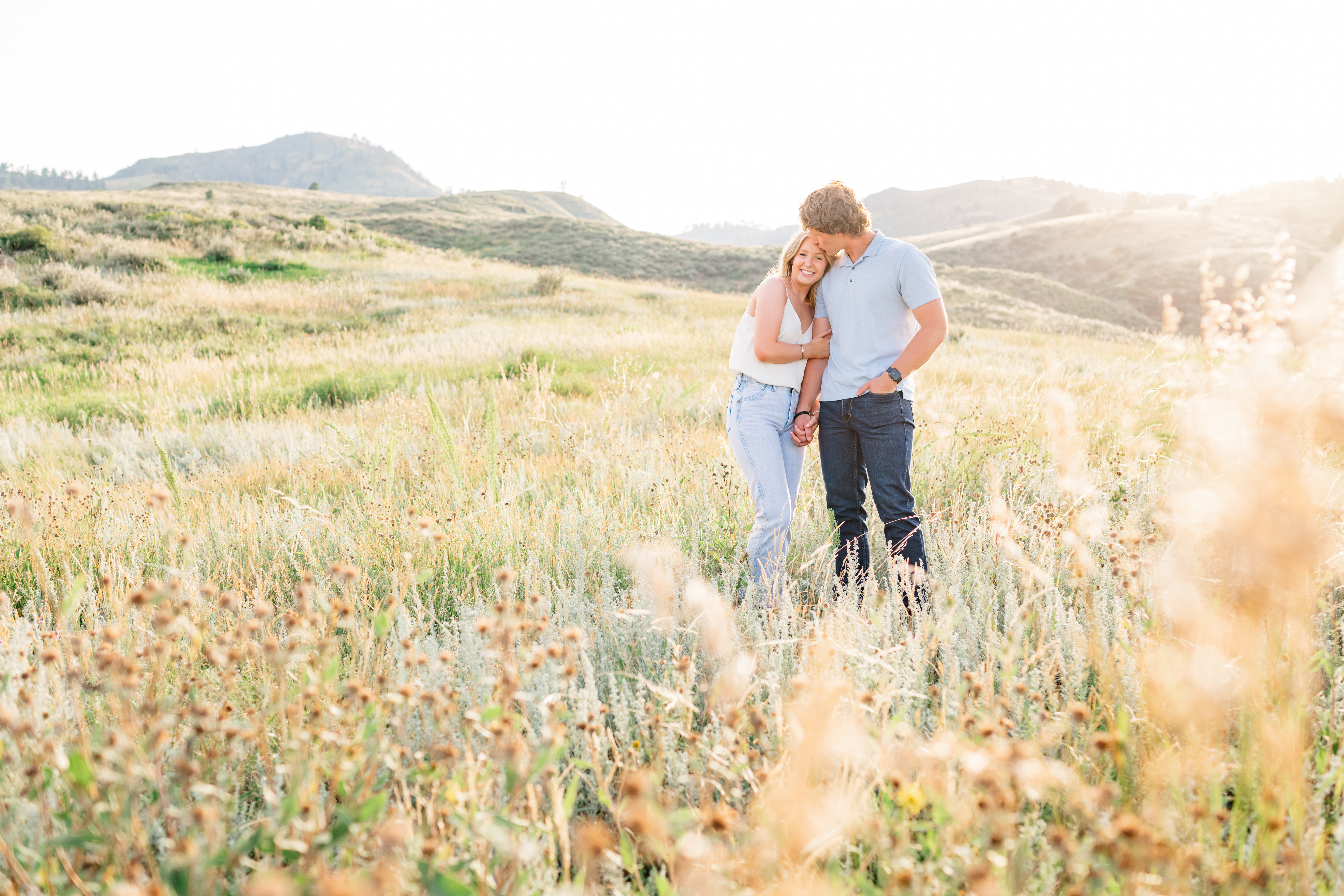 Romantic summer engagement in Fort Collins, Colorado, with the dreamiest rolling hills and sunkissed glow near Horsetooth reservoir and Lory State Park | Britni Girard Photography